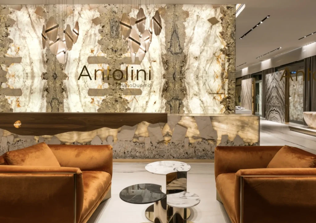 Antolini showroom interior featuring illuminated natural stone slabs, luxury marble surfaces, and Italian design craftsmanship