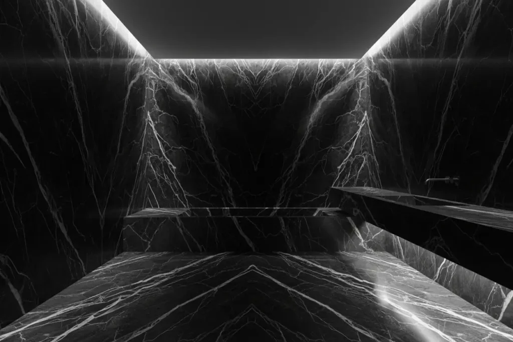 Floor-to-ceiling bookmatched marble bathroom creating a seamless monolithic architectural space