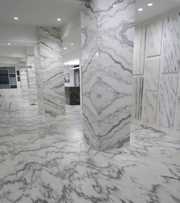Vermont Quarries showroom showcasing book-matched Danby marble slabs on floors and columns